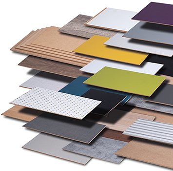 A variety of Homanit fiberboard panels in various colors and natural wood grain patterns
